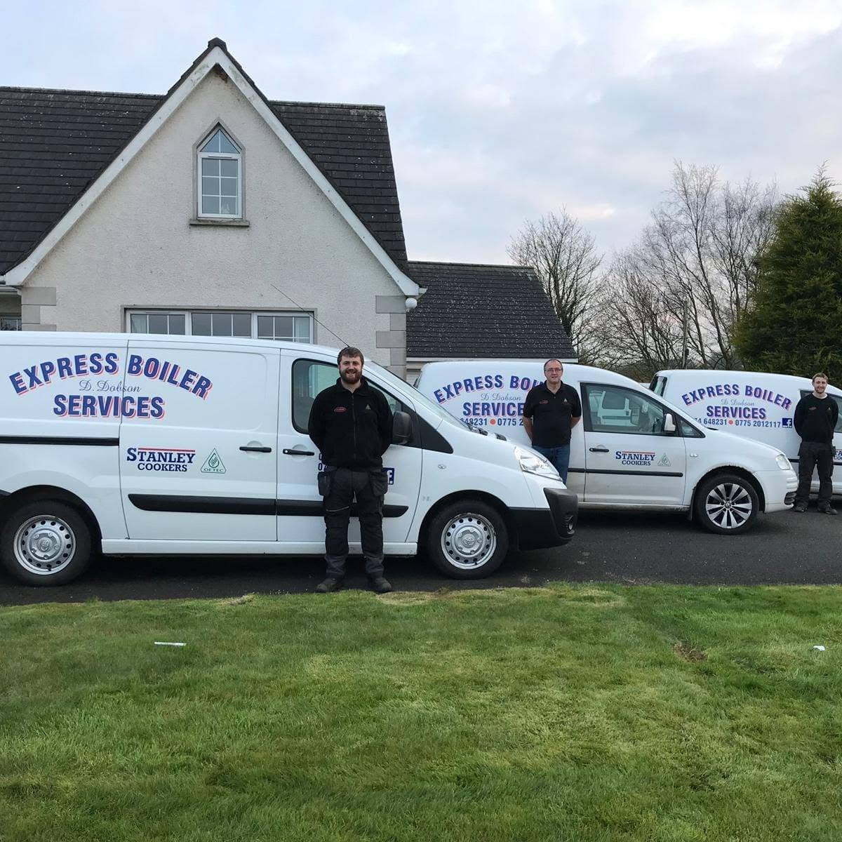 The Express Boiler Services team beside their signwritten vans